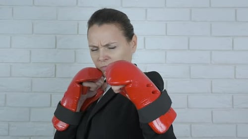 Woman Punching in Boxing Gloves.