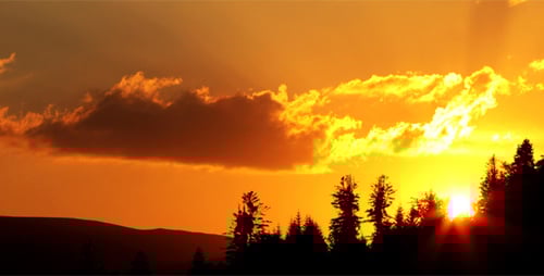 Orange Sun Glimmering Behind Clouds, Panning Shot
