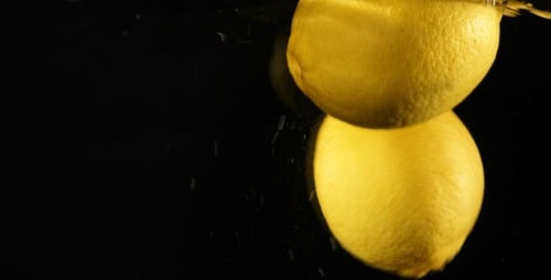 Bright Lemons Floating Gently in Clear Water