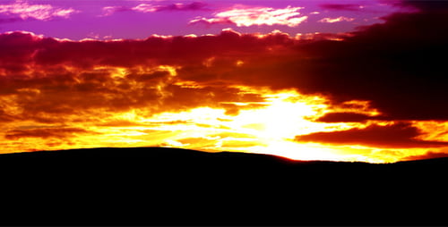 Radiant Sunset Time-Lapse Over Mountain Range