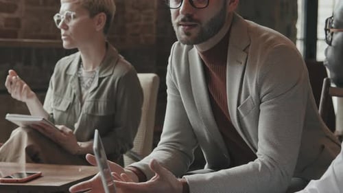 Handsome Businessman Discussing Work with Colleagues