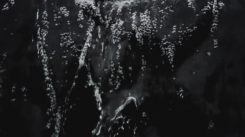 Falling and splashing water on black background