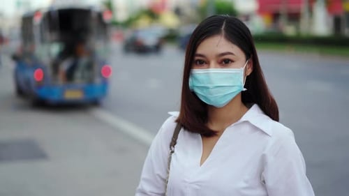 woman in city street and wearing face mask protective for spreading of coronavirus pandemic