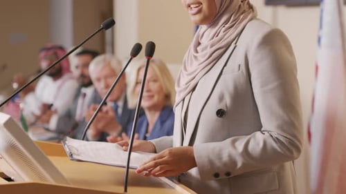Woman Giving Speech at International Conference