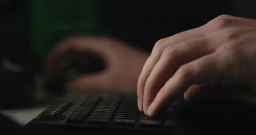 Close Up of Hands Typing on Keyboard at Night