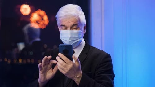 Man Wearing Mask Using Phone During Fireworks