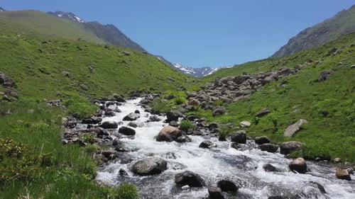 Mountain River Flowing Through Green Valley
