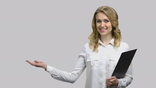 Woman Holding Clipboard Presenting to the Side