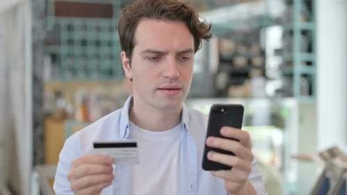 Portrait of Creative Man with Unsuccessful Online Payment on Smartphone