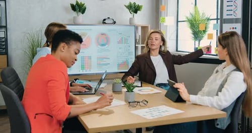 Female Team which Brainstorming Together Over Joint Business Strategy During Meeting in Office