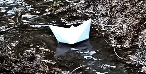 Paper Ship Floating On A Stream