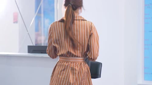 Woman Checks in with Face Mask and Luggage