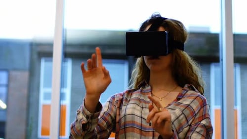 Woman Gesturing While Using Virtual Reality Headset