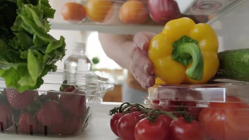 View Inside the Refrigerator Hand Takes Food From the Refrigerator