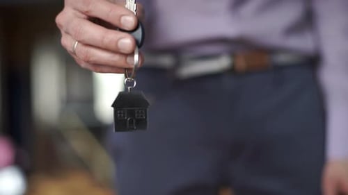 Hand Holding Keys to a New House