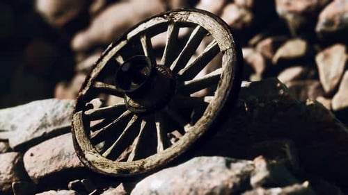 Aged Wooden Wagon Wheel on Rustic Rocks