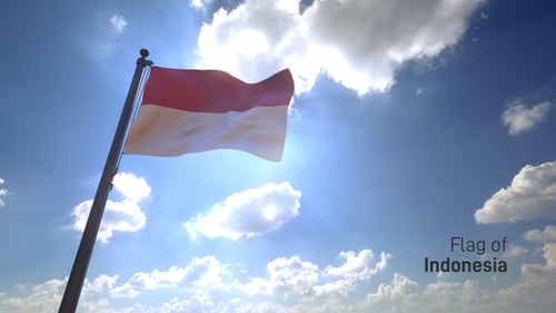 Indonesia Flag Waving in Sunlight Against Blue Sky