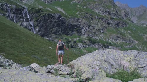 Woman Backpacker Hiking In Mountain