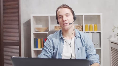 Workplace of freelance worker at home office. Young man works using computer.
