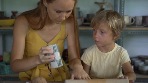 Woman and Boy Working with Clay in Studio