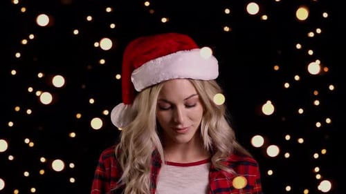 Woman Smiling Wearing Santa Hat and Holiday Lights