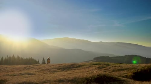 Mountain Hiker Exploring Serene Landscape at Sunrise