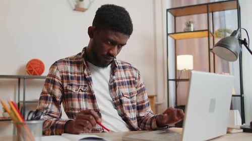 Young Man Guy Using Laptop Computer Sitting at Table Working Online Shopping From Home Office