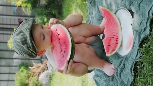 Baby Enjoying Fresh Watermelon in Summer Garden