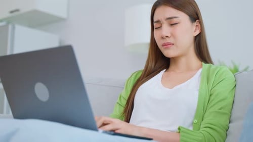 Young Woman Using Laptop at Home