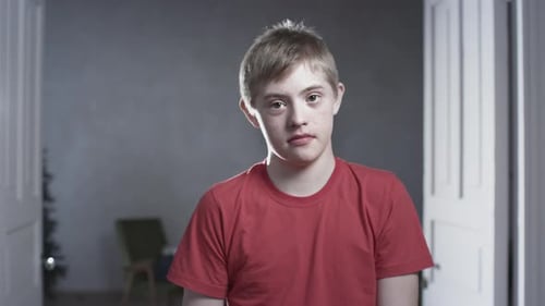 Young Boy Smiles Indoors at the Camera