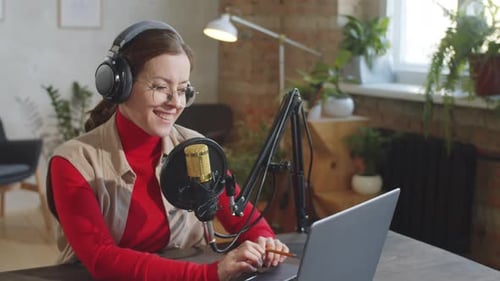 Cheerful Woman Recording Podcast in Studio