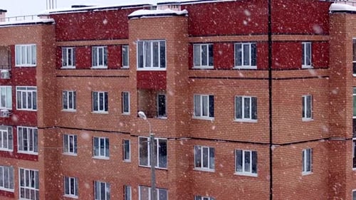 Snow Falling on Apartment Building in the City