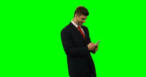 Young Adult Man Uses Phone on Green Screen