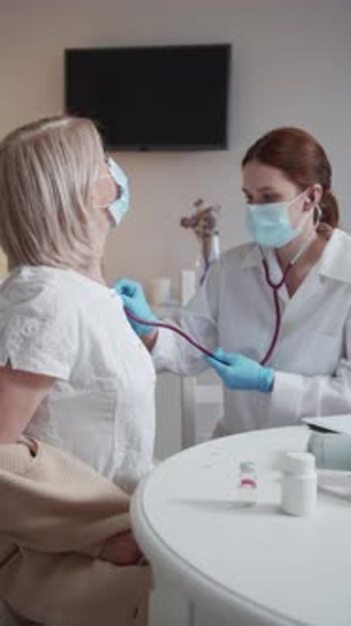 Doctor Listens to Patient's Lungs With Stethoscope