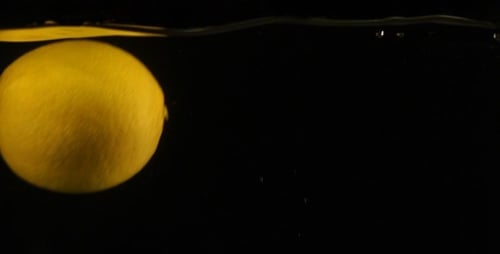 Lemon Falling Into Water in Macro Shot