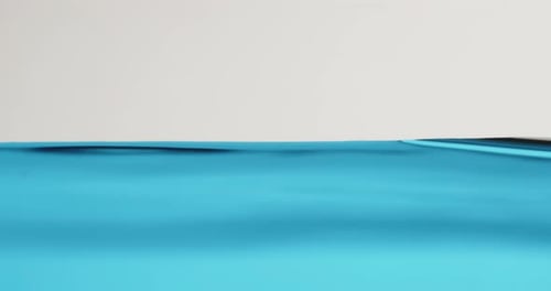 Blue Water Surface In Motion With Waves Creating Abstract Shapes