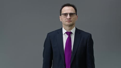Ernsthafter männlicher Chef zeigt auf Uhr in seiner Hand mit Zeit 8 Uhr morgens, Zeitmanagement