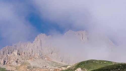 Scenic Mountain Range with Drifting Clouds