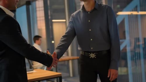 Two Entrepreneur Shaking Hands Inside of Modern Business Office with Huge Windows