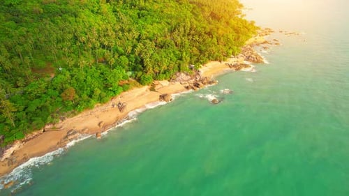 Aerial Top views over beaches, ocean waves crashing on rocks and sand
