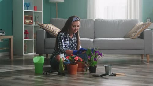 Young Woman Gardening with Flowers Indoors