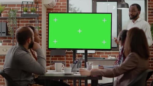 People Talking and Using Isolated Green Screen on Display in Office