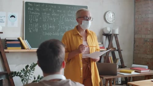 Teacher Lecturing to Students in Classroom Setting