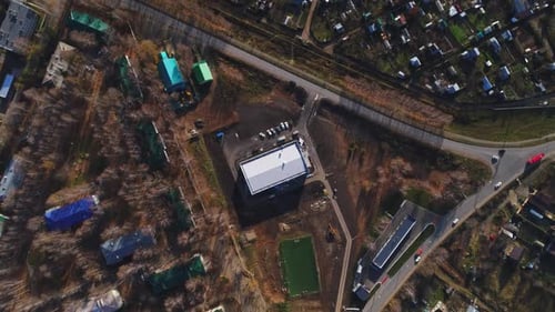White Sports Arena Building and Soccer Field in City