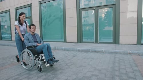 Woman Walking with a Disabled Person