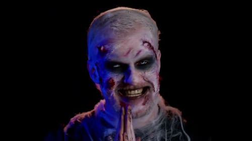 Zombie Man with Scary Makeup in Dark