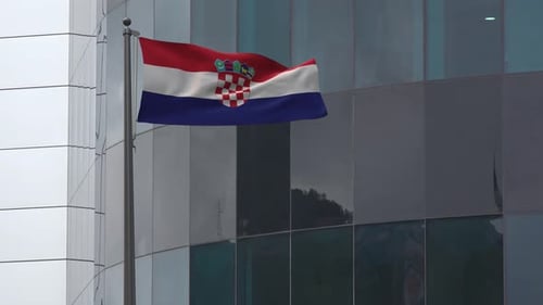 Realistic Croatian Flag Waving on Flagpole with Modern Building Background