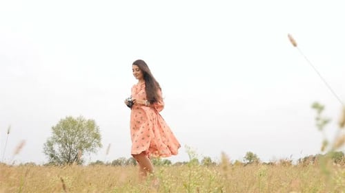 Woman Taking Pictures in Beautiful Rural Field