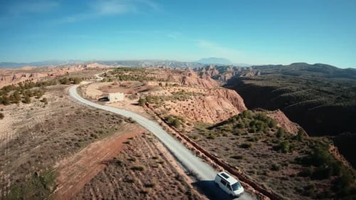 Aerial Shot of Camping Van on Gravel Mountain Road