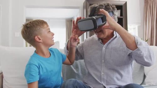 Man Experiences VR with Grandson on Couch